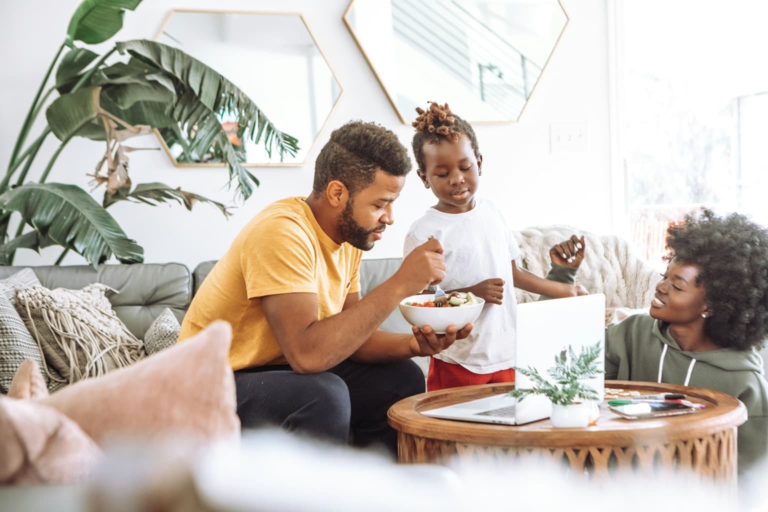 A family sharing a healthy meal together in a bright living room.